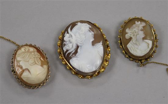 Three assorted mounted cameo brooches including 9ct gold, largest 44mm.